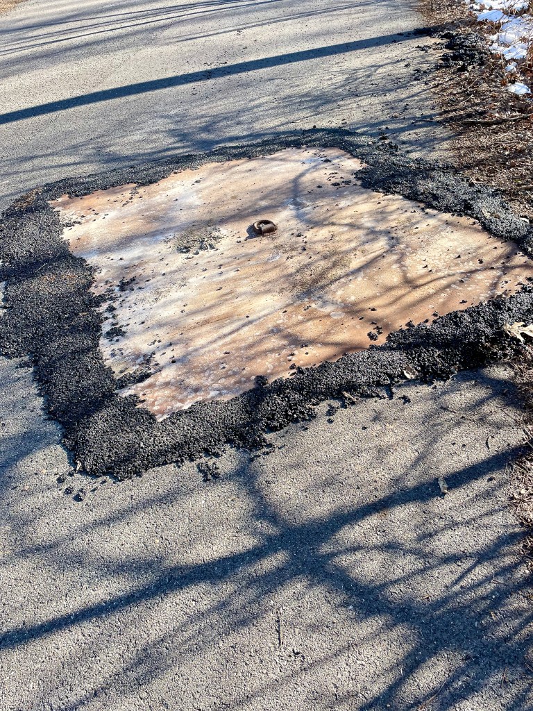 Door in asphalt. What?