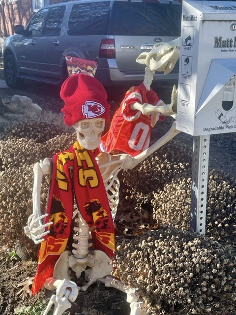 Fake skeletons of a human and dog, both wearing Kansas City Chiefs attire