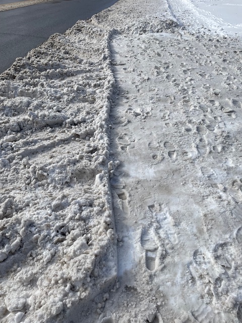 Piles of rutted snow at the end of a driveway