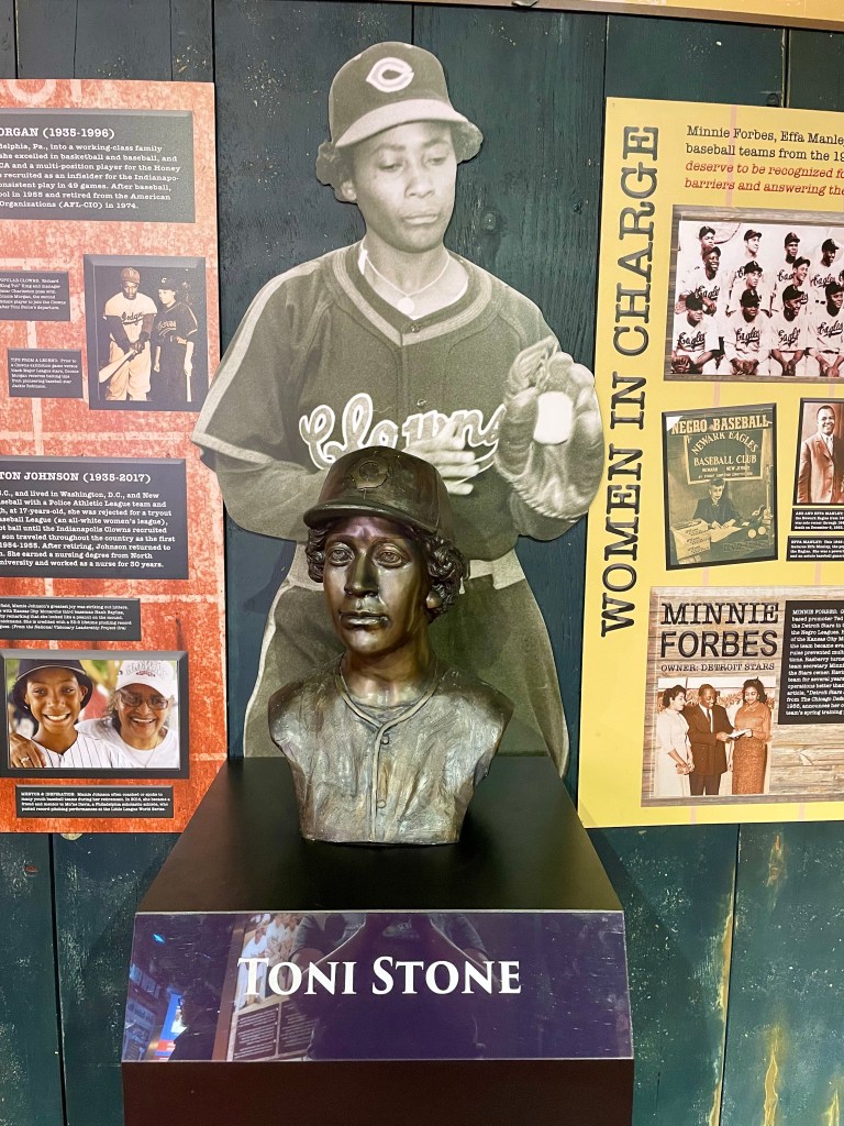 Bust of baseball player Toni Stone in front of cutout image of her