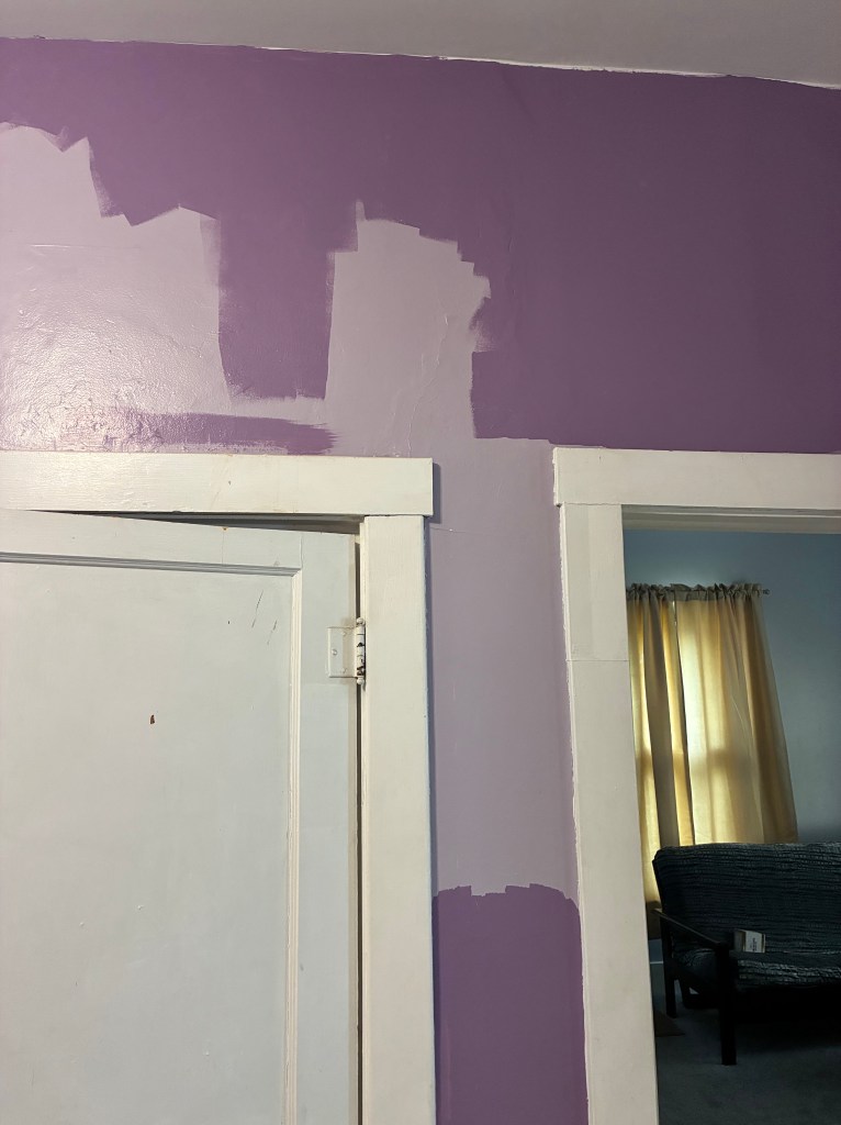 wall with two different shades of purple paint on it