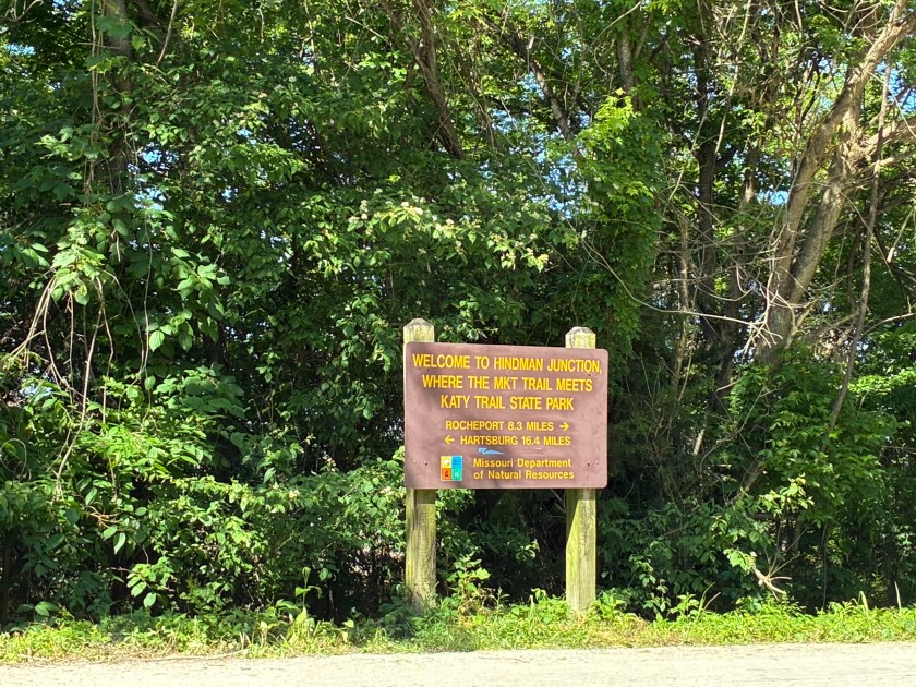 Sign by trail "Welcome to Hindman Junction, where the MKT Trail meets Katy Trail State Park."